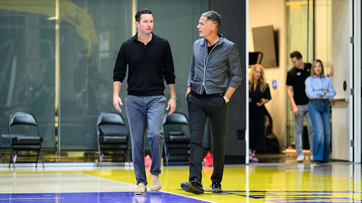 Sep 25, 2025; El Segundo, CA, USA; Los Angeles Lakers head coach JJ Redick, left, and general manager Rob Pelinka arrive to a press conference to preview the 2025-26 season at UCLA Health Training Center. Mandatory Credit: William Liang-Imagn Images