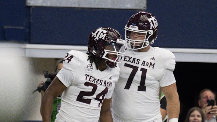 Sep 30, 2023; Arlington, Texas, USA; Texas A&M Aggies running back Earnest Crownover (24) and offensive lineman Chase Bisontis (71) celebrate after Crownover scores a touchdown against the Arkansas Razorbacks during the first half at AT&T Stadium. Mandatory Credit: Jerome Miron-Imagn Images