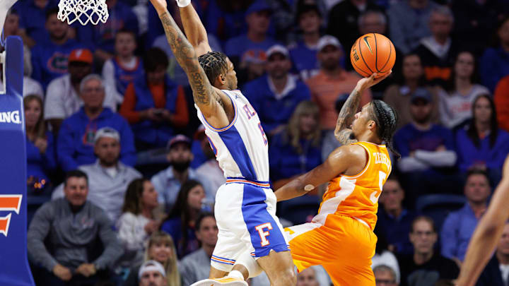 Jan 7, 2025; Gainesville, Florida, USA; Tennessee Volunteers guard Zakai Zeigler (5) attempts a layup over Florida Gators guard Alijah Martin (15) during the second half at Exactech Arena at the Stephen C. O'Connell Center. Mandatory Credit: Matt Pendleton-Imagn Images