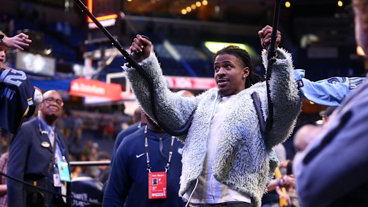Nov 8, 2024; Memphis, Tennessee, USA; Memphis Grizzlies guard Ja Morant (12) holds up his crutches as he celebrates with fans after a game against the Washington Wizards at FedExForum. 
