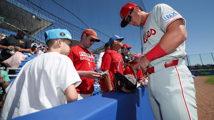 Mar 2, 2025; Dunedin, Florida, USA; Philadelphia Phillies infielder Aidan Miller (81) signs autographs for fans before a game against the Toronto Blue Jays during spring training at TD Ballpark.