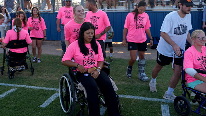 Minco High School softball players make their way to be honored on the football field weeks after being involved in a bus crash. Minco High School softball players make their way to be honored on the football field weeks after being involved in a bus crash.