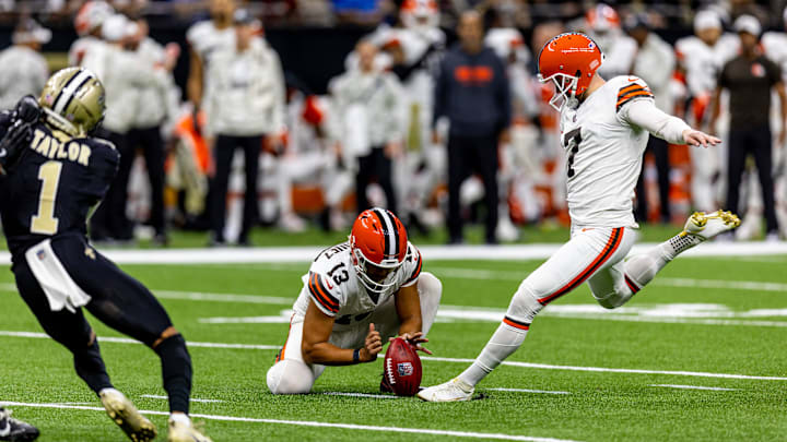 Nov 17, 2024; New Orleans, Louisiana, USA;  Cleveland Browns place kicker Dustin Hopkins (7) attempts a field goal against New Orleans Saints cornerback Alontae Taylor (1) during the first half at Caesars Superdome. Mandatory Credit: Stephen Lew-Imagn Images
