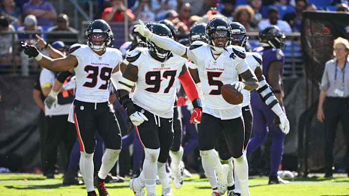 Jalen Pitre and the Houston Texans defense celebrates following a turnover in their 44-10 win over the Baltimore Ravens 