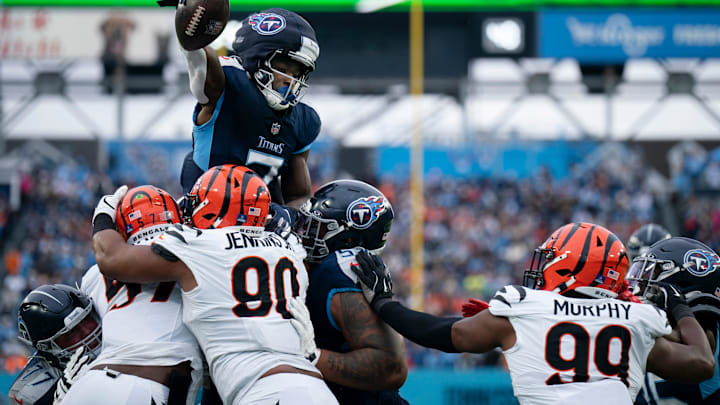Tennessee Titans running back Tyjae Spears (2) leaps and holds the ball across the goal line while the Cincinnati Bengals defense tries to stop him from scoring during their game at Nissan Stadium in Nashville, Tenn., Sunday, Dec. 15, 2024.