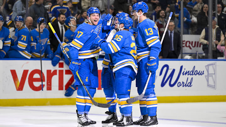 Nov 14, 2025; St. Louis, Missouri, USA; St. Louis Blues defenseman Cam Fowler (17) is congratulated by teammates after assisting on a goal by defenseman Justin Faulk (72) for his 500th career point in the NHL during the second period against the Philadelphia Flyers at Enterprise Center. Mandatory Credit: Jeff Curry-Imagn Images