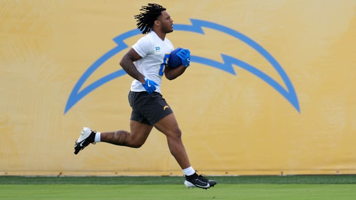 Los Angeles Chargers running back Omarion Hampton carries the ball during offseason workouts at The Bolt. Los Angeles Chargers running back Omarion Hampton carries the ball during offseason workouts at The Bolt.