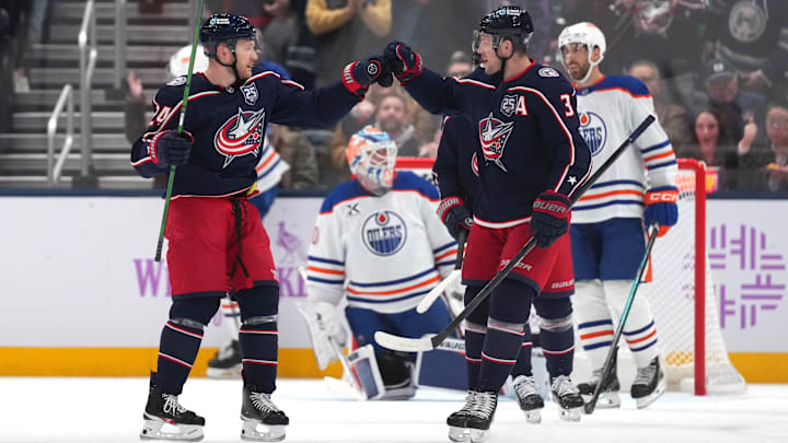 Blue Jackets forwards Mathieu Olivier and Charlie Coyle celebrate a goal against the Edmonton Oilers.