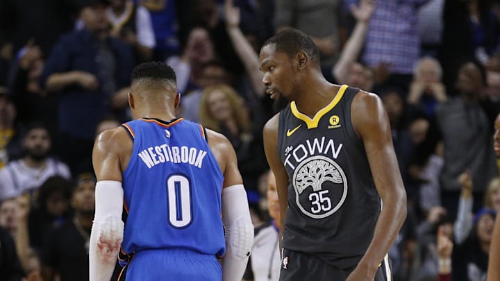 Feb 6, 2018; Oakland, CA, USA; Golden State Warriors forward Kevin Durant (35) walks past Oklahoma City Thunder guard Russell Westbrook (0) before a free throw attempt by Westrbook in the third quarter at Oracle Arena. Mandatory Credit: Cary Edmondson-Imagn Images