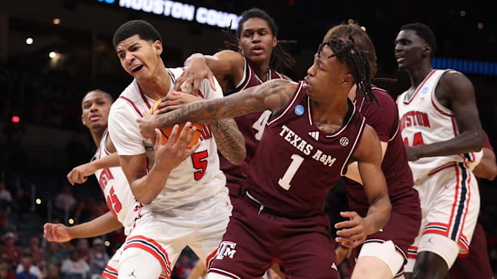 Mar 21, 2026; Oklahoma City, OK, USA; Houston Cougars center Chris Cenac Jr. (5) and Texas A&M Aggies guard Josh Holloway (1) battle for control of the ball during the first half of a second round game of the men's 2026 NCAA Tournament at Paycom Center. Mandatory Credit: William Purnell-Imagn Images Mar 21, 2026; Oklahoma City, OK, USA; Houston Cougars center Chris Cenac Jr. (5) and Texas A&M Aggies guard Josh Holloway (1) battle for control of the ball during the first half of a second round game of the men's 2026 NCAA Tournament at Paycom Center. Mandatory Credit: William Purnell-Imagn Images