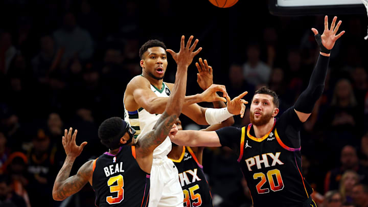 Feb 6, 2024; Phoenix, Arizona, USA; Milwaukee Bucks forward Giannis Antetokounmpo (34) passes the ball against Phoenix Suns guard Bradley Beal (3) and center Jusuf Nurkic (20) during the third quarter at Footprint Center. Mandatory Credit: Mark J. Rebilas-Imagn Images