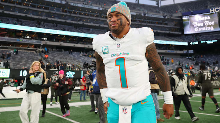 Dec 7, 2025; East Rutherford, New Jersey, USA; Miami Dolphins quarterback Tua Tagovailoa (1) walks on the field after the game against the New York Jets at MetLife Stadium. Mandatory Credit: Ed Mulholland-Imagn Images
