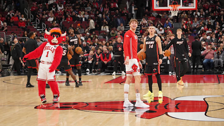 Jan 8, 2026; Chicago, Illinois, USA; Chicago Bulls forward Matas Buzelis (14) and Miami Heat guard Tyler Herro (14) take backward half courts shots as the game against the Miami Heat is delayed because of condensation on the court due to humidity and rain at United Center. Mandatory Credit: David Banks-Imagn Images
