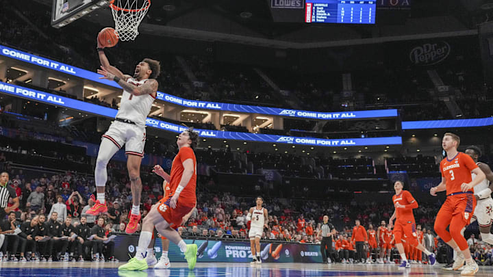 Mar 14, 2025; Charlotte, NC, USA; Louisville Cardinals guard J'Vonne Hadley (1) drives to the basket against Clemson Tigers forward Ian Schieffelin (4) during the second half at Spectrum Center. Mandatory Credit: Jim Dedmon-Imagn Images