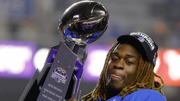Boise State Broncos running back Ashton Jeanty (2) hoists the Mountain West Trophy.