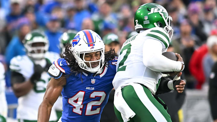 Dec 29, 2024; Orchard Park, New York, USA; Buffalo Bills linebacker Dorian Williams (42) tackles New York Jets quarterback Tyrod Taylor (2) in the fourth quarter
