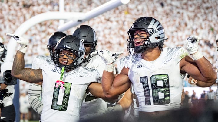 Oregon running back Jordon Davison, left and Oregon tight end Kenyon Sadiq celebrate a touchdown by Davison as the Oregon Ducks face the Penn State Nittany Lions on Sept. 27, 2025, at Beaver Stadium in University Park, Pennsylvania.