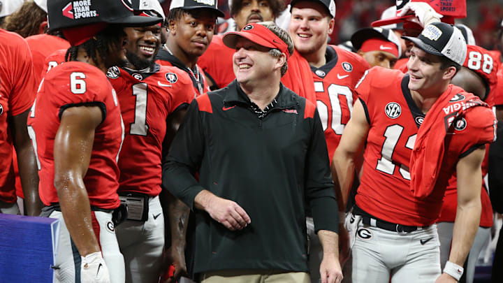 Dec 3, 2022; Atlanta, GA, USA; Georgia Bulldogs running back Kenny McIntosh (6), head coach Kirby Smart, and quarterback Stetson Bennett (13) celebrate after a victory in the SEC Championship against the LSU Tigers at Mercedes-Benz Stadium. Mandatory Credit: Brett Davis-Imagn Images