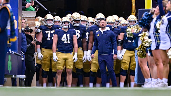 Nov 16, 2024; South Bend, Indiana, USA; Notre Dame Fighting Irish head coach Marcus Freeman prepares to lead his players onto the field for the game against the Virginia Cavaliers at Notre Dame Stadium. Mandatory Credit: Matt Cashore-Imagn Images