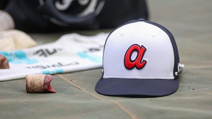 Apr 10, 2024; Atlanta, Georgia, USA; A detailed view of an Atlanta Braves hat on the field during batting practice at Truist Park. The game against the New York Mets was postponed due to impending weather. Mandatory Credit: Brett Davis-Imagn Images Apr 10, 2024; Atlanta, Georgia, USA; A detailed view of an Atlanta Braves hat on the field during batting practice at Truist Park. The game against the New York Mets was postponed due to impending weather. Mandatory Credit: Brett Davis-Imagn Images