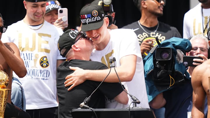 Malone hugs Jokic. 