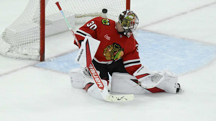 Apr 12, 2025; Chicago, Illinois, USA;  The puck hit by Winnipeg Jets left wing Kyle Connor (81) flies past Chicago Blackhawks goaltender Spencer Knight (30) during the second period at United Center. Mandatory Credit: Matt Marton-Imagn Images