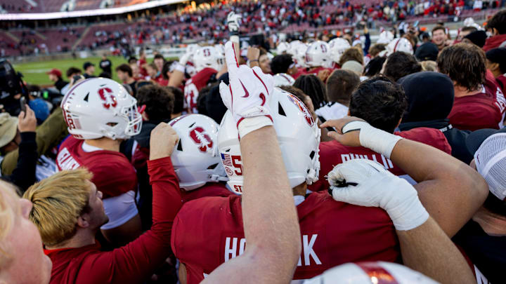 Nov 16, 2024; Stanford, California, USA;  Stanford Cardinal players celebrates after defeating the Louisville Cardinals at Stanford Stadium. Mandatory Credit: Bob Kupbens-Imagn Images