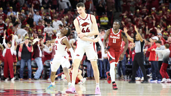 Feb 8, 2025; Fayetteville, Arkansas, USA; Arkansas Razorbacks forwards Adou Thiero (3) and Zvonimir Ivisic (44) celebrate after a three point shot in the second half by Ivisic as Alabama Crimson Tide center Clifford Omoruyi (11) looks on at Bud Walton Arena. Alabama won 85-81. Mandatory Credit: Nelson Chenault-Imagn Images