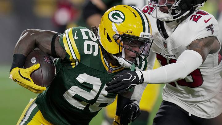 Green Bay Packers running back Kaleb Johnson (26) is stopped for a short gain by Atlanta Falcons cornerback C.J. Henderson (26) during the second quarter of their game Thursday, Sept. 24, 2026 at Lambeau Field in Green Bay, Wisconsin.