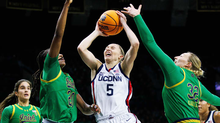 UConn guard Paige Bueckers (5) takes the ball up against Notre Dame forward Liatu King (20) and forward Liza Karlen (32) during a NCAA women's basketball game between No. 8 Notre Dame and No. 2 UConn at Purcell Pavilion on Thursday, Dec. 12, 2024, in South Bend. UConn guard Paige Bueckers (5) takes the ball up against Notre Dame forward Liatu King (20) and forward Liza Karlen (32) during a NCAA women's basketball game between No. 8 Notre Dame and No. 2 UConn at Purcell Pavilion on Thursday, Dec. 12, 2024, in South Bend.