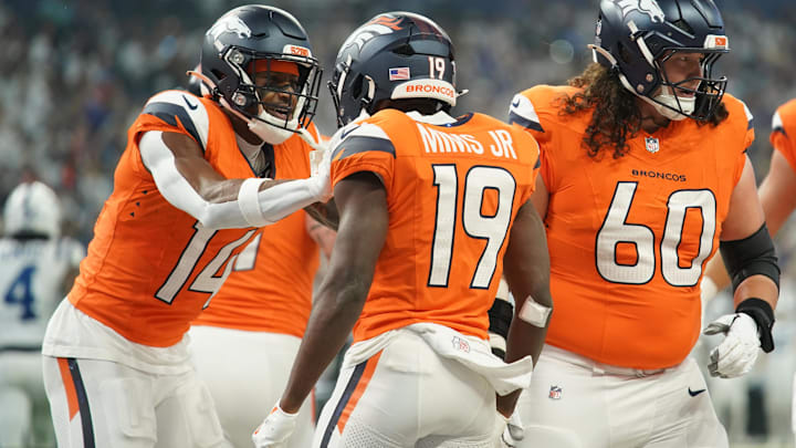Sep 14, 2025; Indianapolis, Indiana, USA; Denver Broncos wide receiver Marvin Mims Jr. (19) celebrates scoring a touchdown with wide receiver Courtland Sutton (14) and center Luke Wattenberg (60) during the first quarter against the Indianapolis Colts at Lucas Oil Stadium. Mandatory Credit: Robert Goddin-Imagn Images