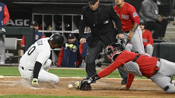 Apr 11, 2025; Chicago, Illinois, USA; Chicago White Sox third base Lenyn Sosa (50) slides safely into home plate as Boston Red Sox catcher Blake Sabol (18) misses the tag during the eighth inning at Guaranteed Rate Field. Mandatory Credit: Matt Marton-Imagn Images