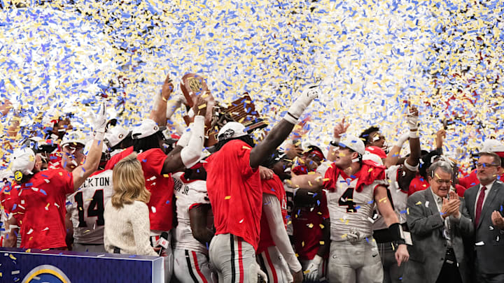 Dec 6, 2025; Atlanta, GA, USA; The Georgia Bulldogs are presented with the SEC Championship trophy after the game against the Alabama Crimson Tide during the 2025 SEC Championship game at Mercedes-Benz Stadium. Mandatory Credit: Dale Zanine-Imagn Images