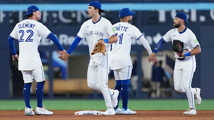 Jul 21, 2025; Toronto, Ontario, CAN; Toronto Blue Jays shortstop Bo Bichette (11) celebrates the win with Toronto Blue Jays right ielder Nathan Lukes (38) against the New York Yankees at the end of the ninth inning at Rogers Centre.