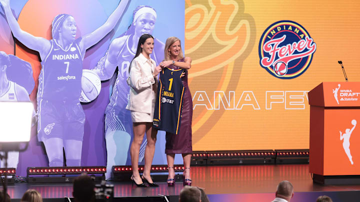 Apr 15, 2024; Brooklyn, NY, USA; Caitlin Clark poses with WNBA commissioner Cathy Engelbert after she is selected with the number one overall pick to the Indiana Fever in the 2024 WNBA Draft at Brooklyn Academy of Music. Mandatory Credit: Vincent Carchietta-Imagn Images