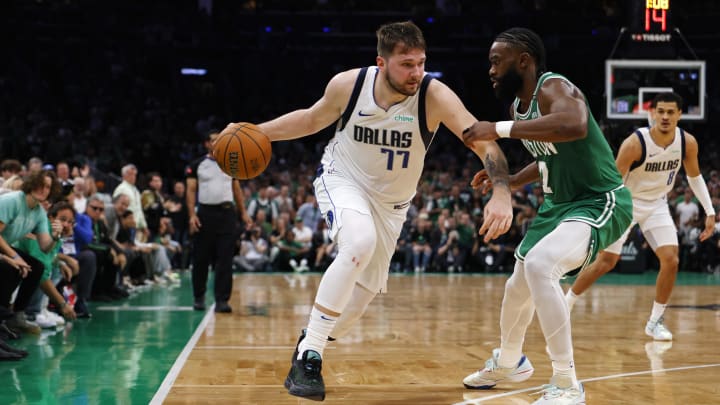 Jun 17, 2024; Boston, Massachusetts, USA; Dallas Mavericks guard Luka Doncic (77) dribbles the ball against Boston Celtics guard Jaylen Brown (7) during the second quarter in game five of the 2024 NBA Finals at TD Garden. Mandatory Credit: Peter Casey-USA TODAY Sports