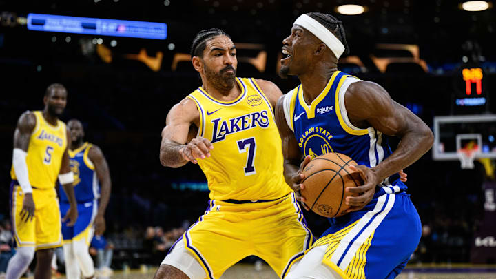 Oct 21, 2025; Los Angeles, California, USA; Golden State Warriors forward Jimmy Butler III (10) drives against Los Angeles Lakers guard Gabe Vincent (7) during the second half at Crypto.com Arena. Mandatory Credit: William Liang-Imagn Images