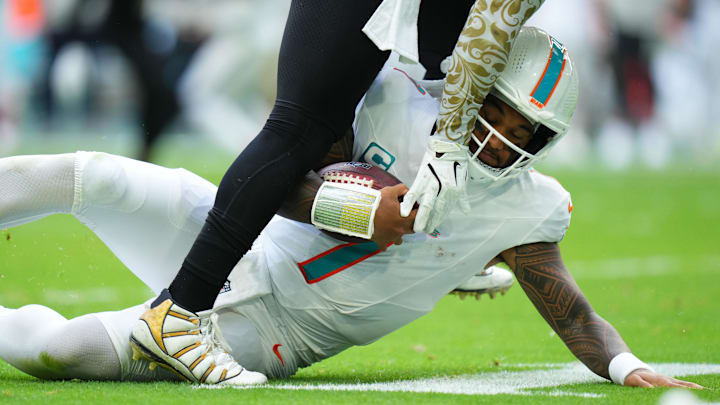 Miami Dolphins quarterback Tua Tagovailoa (1) slides down against the New Orleans Saints during the second half at Hard Rock Stadium. 