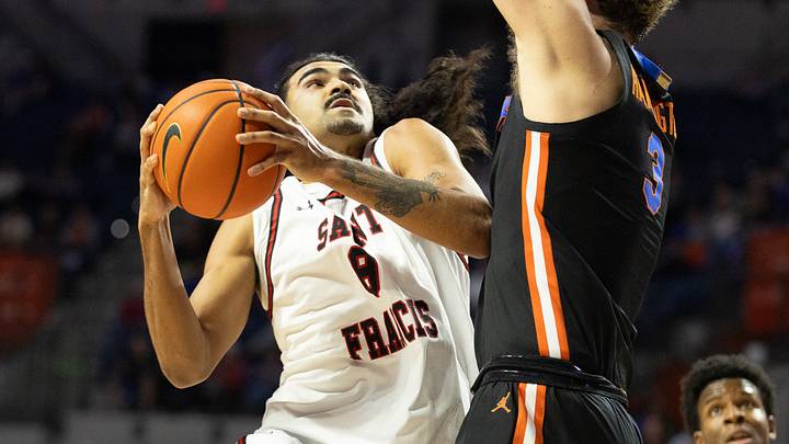 Saint Francis guard Skylar Wicks (8) shoots against Florida center Micah Handlogten (3) during the first half of an NCAA mens basketball game at Steven C. O'Connell Center Exactek arena in Gainesville, FL on Wednesday, December 17, 2025. Florida won 76-51 Saint Francis guard Skylar Wicks (8) shoots against Florida center Micah Handlogten (3) during the first half of an NCAA mens basketball game at Steven C. O'Connell Center Exactek arena in Gainesville, FL on Wednesday, December 17, 2025. Florida won 76-51