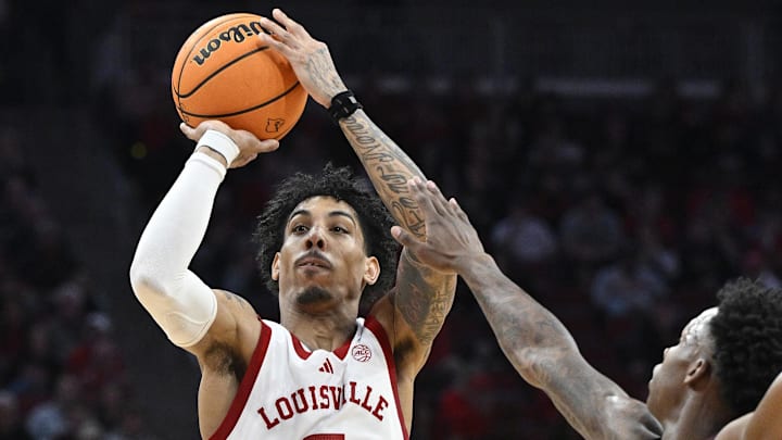 Dec 28, 2024; Louisville, Kentucky, USA;  Louisville Cardinals guard Terrence Edwards Jr. (5) shoots the ball against Eastern Kentucky Colonels guard George Kimble III (3) during the second half at KFC Yum! Center. Louisville won 78-76. Mandatory Credit: Jamie Rhodes-Imagn Images