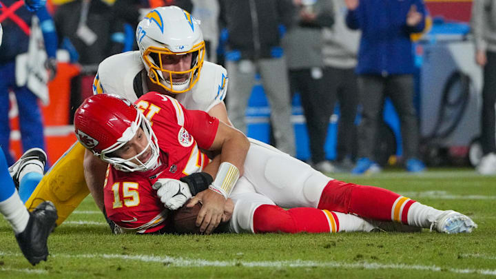 Dec 8, 2024; Kansas City, Missouri, USA; Kansas City Chiefs quarterback Patrick Mahomes (15) is sacked by Los Angeles Chargers linebacker Joey Bosa (97) during the first half at GEHA Field at Arrowhead Stadium. 