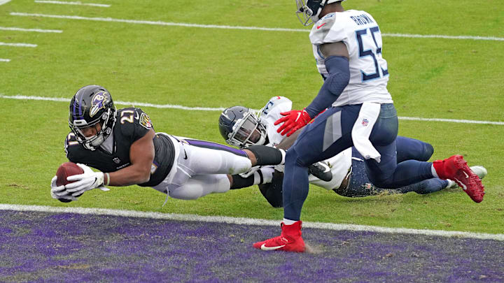 Nov 22, 2020; Baltimore, Maryland, USA; Baltimore Ravens   running back JK Dobbins (27) scores a second quarter two point conversion against the Tennessee Titans at M&T Bank Stadium. Mandatory Credit: Mitch Stringer-USA TODAY Sports