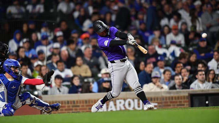 May 27, 2025; Chicago, Illinois, USA; Colorado Rockies second base Tyler Freeman (2) hits a single during the ninth inning against the Chicago Cubs at Wrigley Field. 