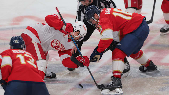 Jan 16, 2025; Sunrise, Florida, USA; Detroit Red Wings center Dylan Larkin (71) and Florida Panthers center Aleksander Barkov (16) face-off during the third period at Amerant Bank Arena. Mandatory Credit: Sam Navarro-Imagn Images