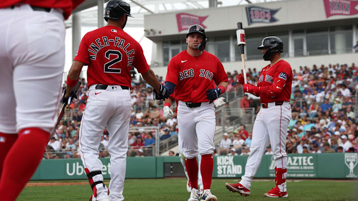 Feb 22, 2026; Fort Myers, Florida, USA;  Boston Red Sox infielder Caleb Durbin (17) is congratulated by infielder Isiah Kiner-Falefa (2) after he scored during the first inning against the Toronto Blue Jays at JetBlue Park at Fenway South. Mandatory Credit: Kim Klement Neitzel-Imagn Images