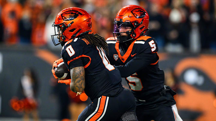 Nov 8, 2025; Corvallis, Oregon, USA;Oregon State Beavers running back Anthony Hankerson (0) takes the handoff from quarterback Gabarri Johnson (5) during the first half against the Sam Houston Bearkats at Reser Stadium. Mandatory Credit: Craig Strobeck-Imagn Images