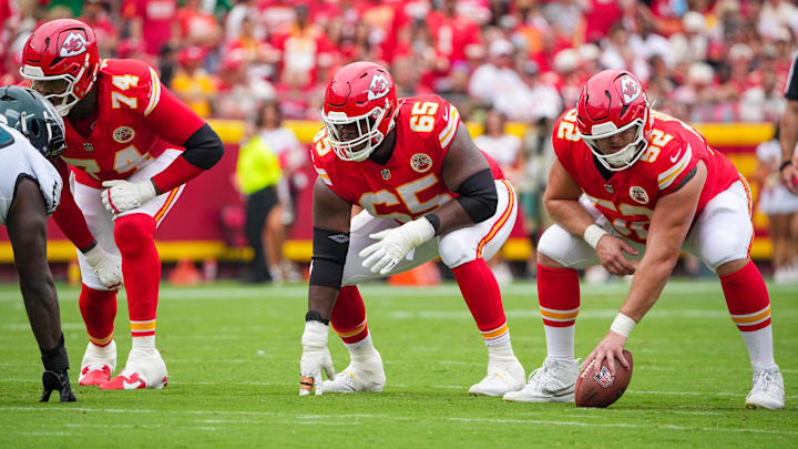 Sep 14, 2025; Kansas City, Missouri, USA; Kansas City Chiefs offensive tackle Jawaan Taylor (74) and guard Trey Smith (65) and center Creed Humphrey (52) at the line of scrimmage against the Philadelphia Eagles during the game at GEHA Field at Arrowhead Stadium. Mandatory Credit: Denny Medley-Imagn Images