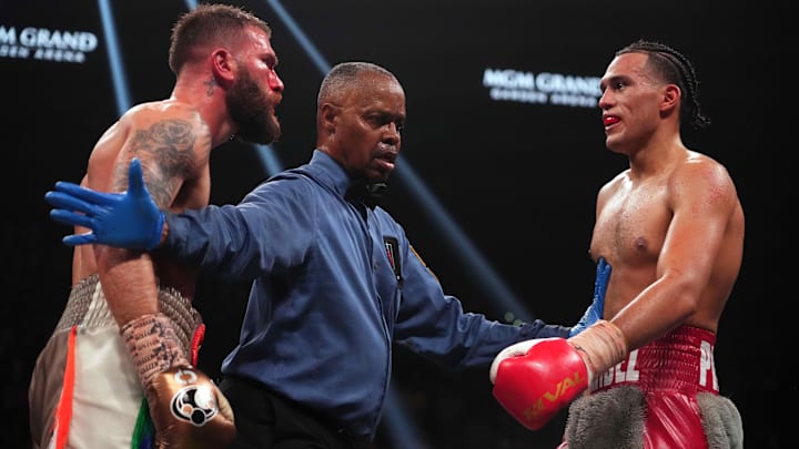 David Benavidez (gray trunks) and Caleb Plant (brown trunks) are separated by referee Kenny Bayless during their Interim WBC Super Middleweight Championship boxing bout at MGM Grand Garden Arena. David Benavidez (gray trunks) and Caleb Plant (brown trunks) are separated by referee Kenny Bayless during their Interim WBC Super Middleweight Championship boxing bout at MGM Grand Garden Arena.