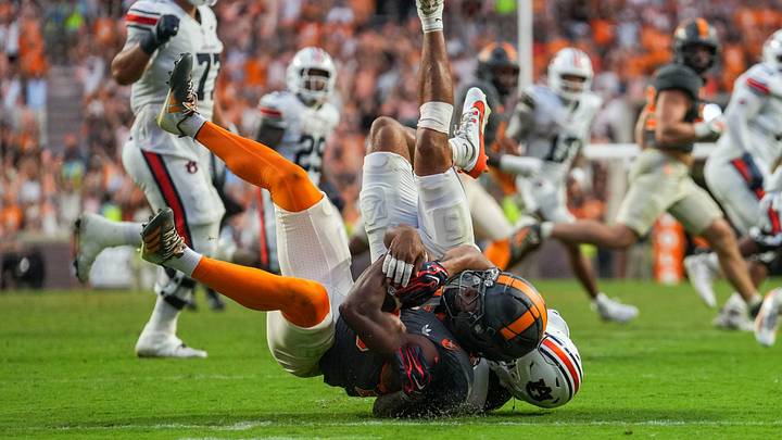 Auburn safety Eric Winters (5) tackles Tennessee defensive back Tevis Metcalf (20) after Metcalf catches an interception during a college football game between Tennessee and Auburn at Neyland Stadium in Knoxville, Tenn., on Oct. 3, 2026.