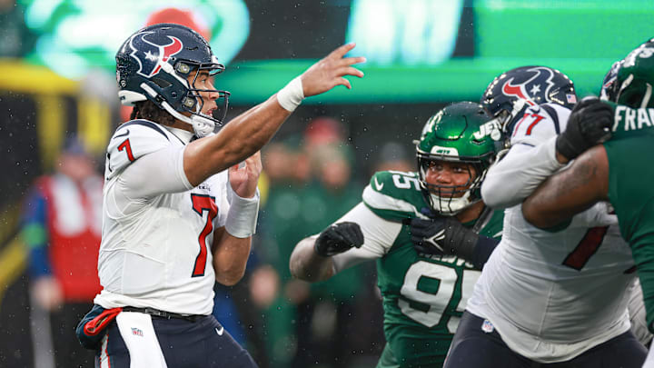 Dec 10, 2023; East Rutherford, New Jersey, USA; Houston Texans quarterback C.J. Stroud (7) throws the ball asNew York Jets defensive tackle Quinnen Williams (95) pursues during the second half at MetLife Stadium.  Stroud was injured on the play and left the game. Mandatory Credit: Vincent Carchietta-USA TODAY Sports